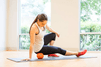 Women using TriggerPoint Grid Ball to message her leg